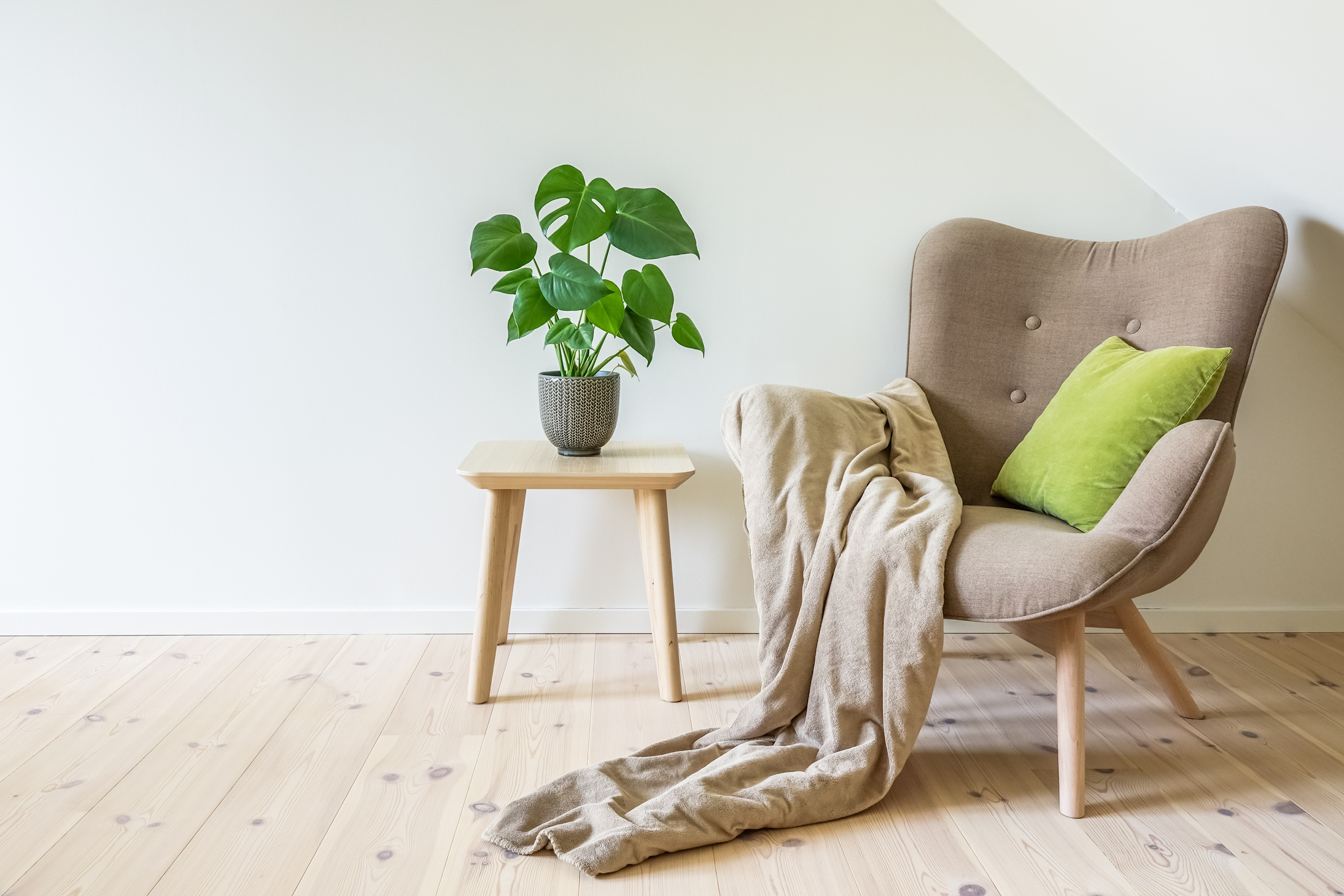 Beige armchair in simple living room interior